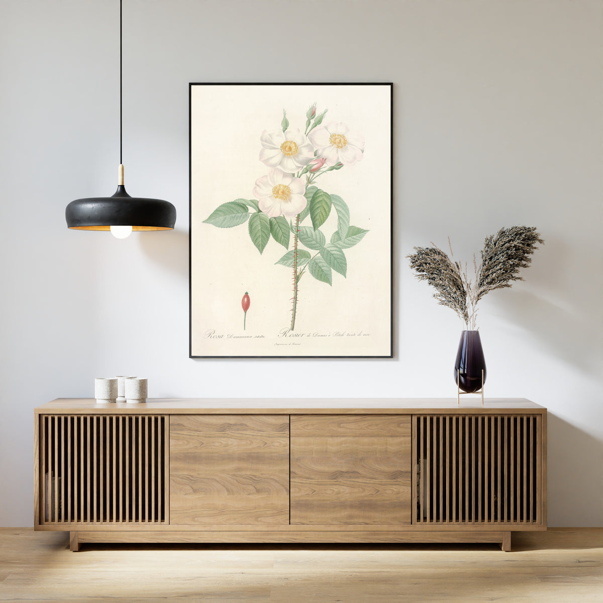 Framed art print of Les Roses: Rosa Damascena Subalba by Pierre-Joseph Redouté, above a slatted wood sideboard