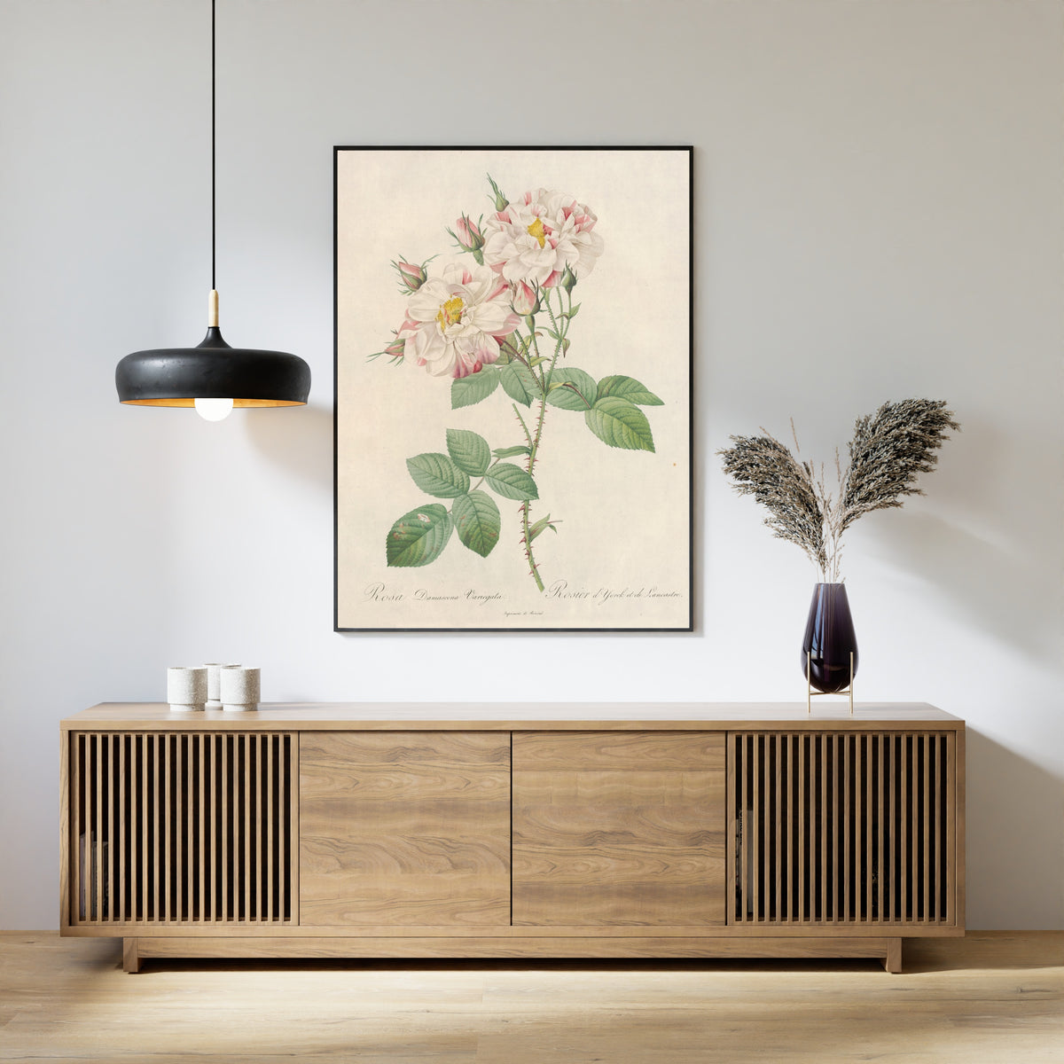 Framed art print of Les Roses: Rosa Damascena Variegata by Pierre-Joseph Redouté, above a slatted wood sideboard