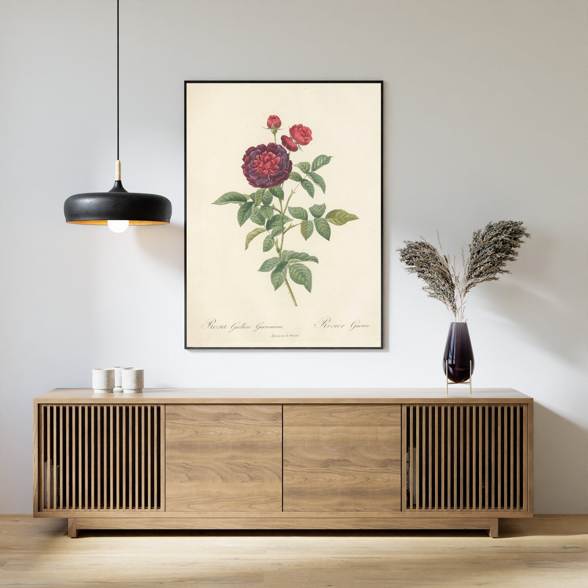Framed art print of Les Roses: Rosa Gallica Gueriniana by Pierre-Joseph Redouté, above a slatted wood sideboard