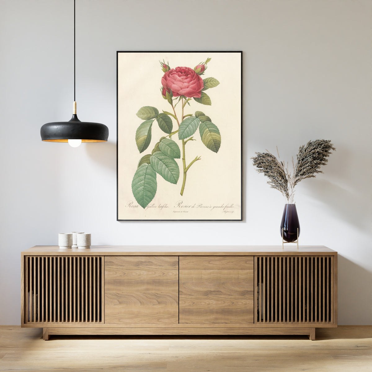 Framed art print of Les Roses: Rosa Gallica Latifolia by Pierre-Joseph Redouté, above a slatted wood sideboard