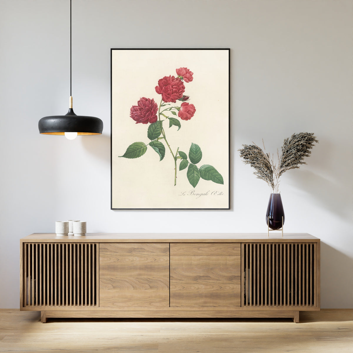 Framed art print of Les Roses: Rosa Indica Caryophyllea by Pierre-Joseph Redouté, above a slatted wood sideboard