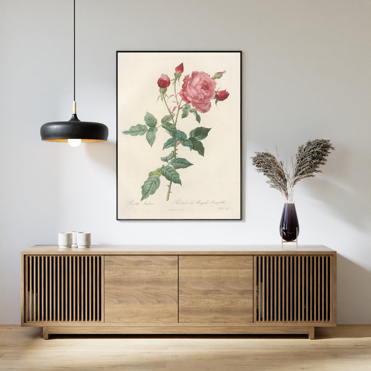 Framed art print of Les Roses: Rosa Indica (Rosier du Bengale Cent-feuilles) by Pierre-Joseph Redouté, above a slatted wood sideboard