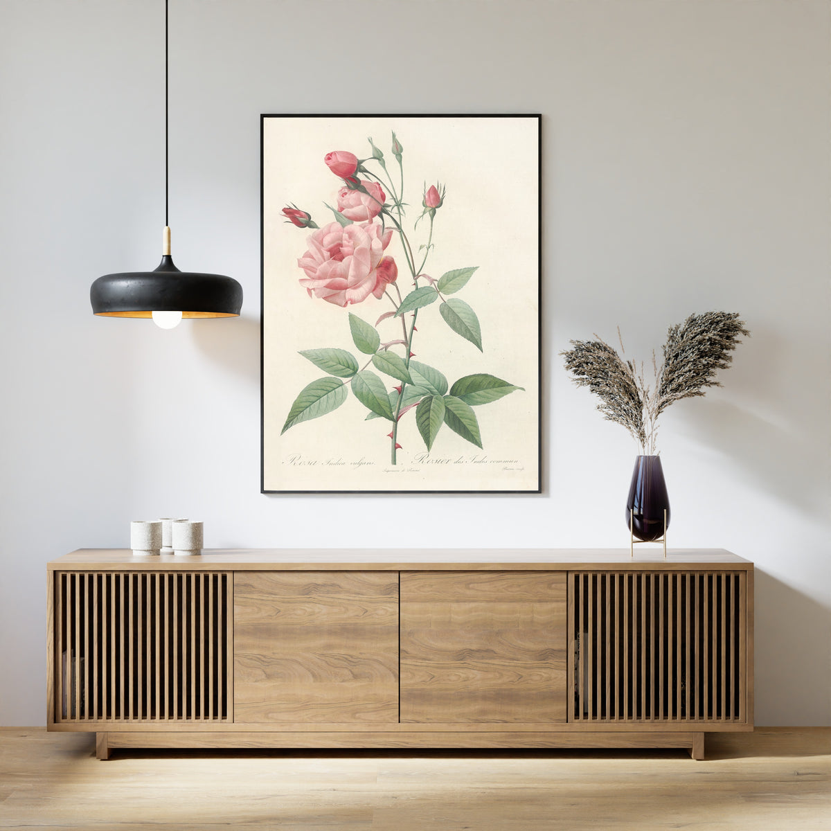 Framed art print of Les Roses: Rosa Indica Vulgaris by Pierre-Joseph Redouté, above a slatted wood sideboard