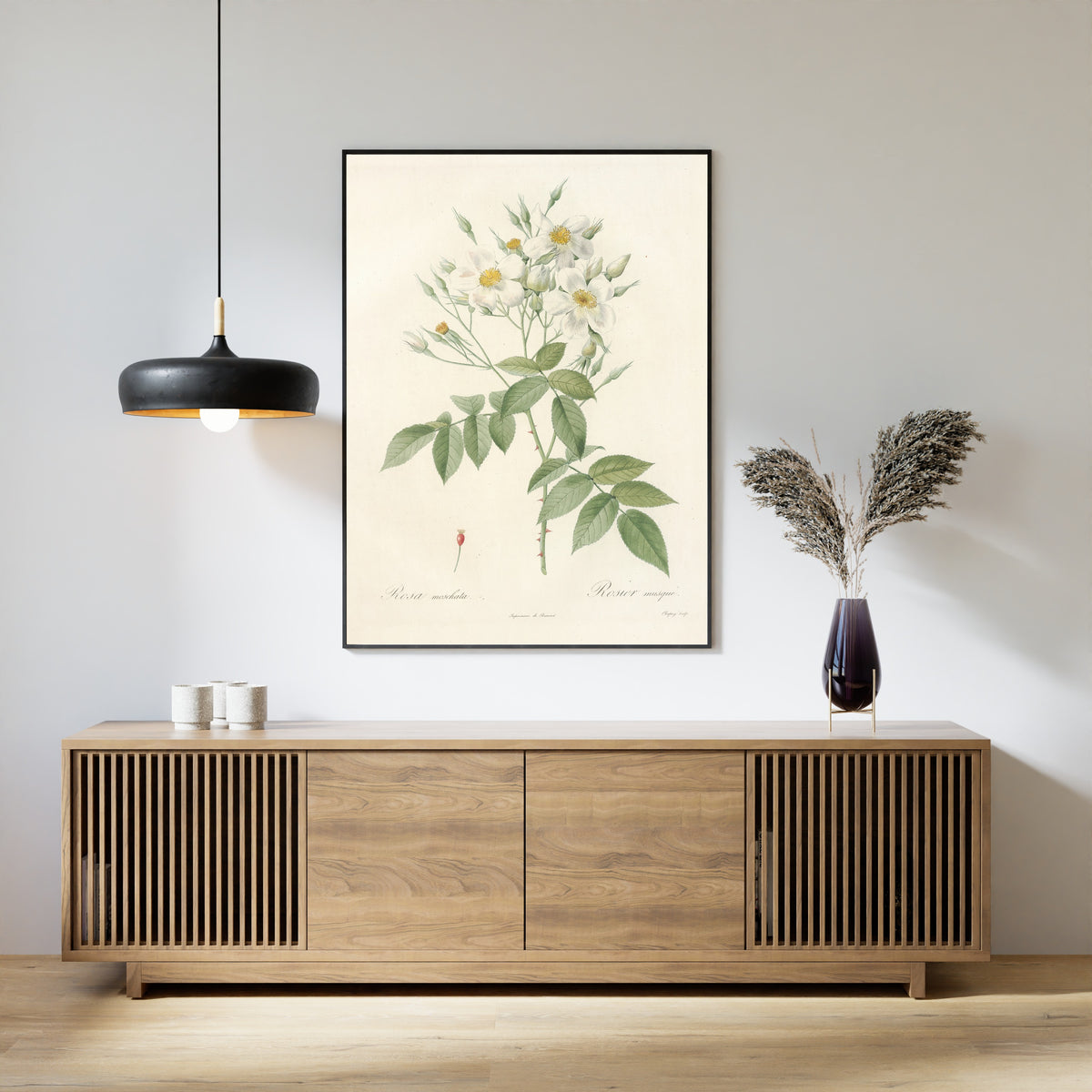 Framed art print of Les Roses: Rosa Moschata by Pierre-Joseph Redouté, above a slatted wood sideboard