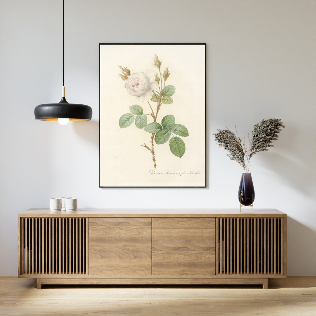 Framed art print of Les Roses: Rosa Muscosa Alba by Pierre-Joseph Redouté, above a slatted wood sideboard