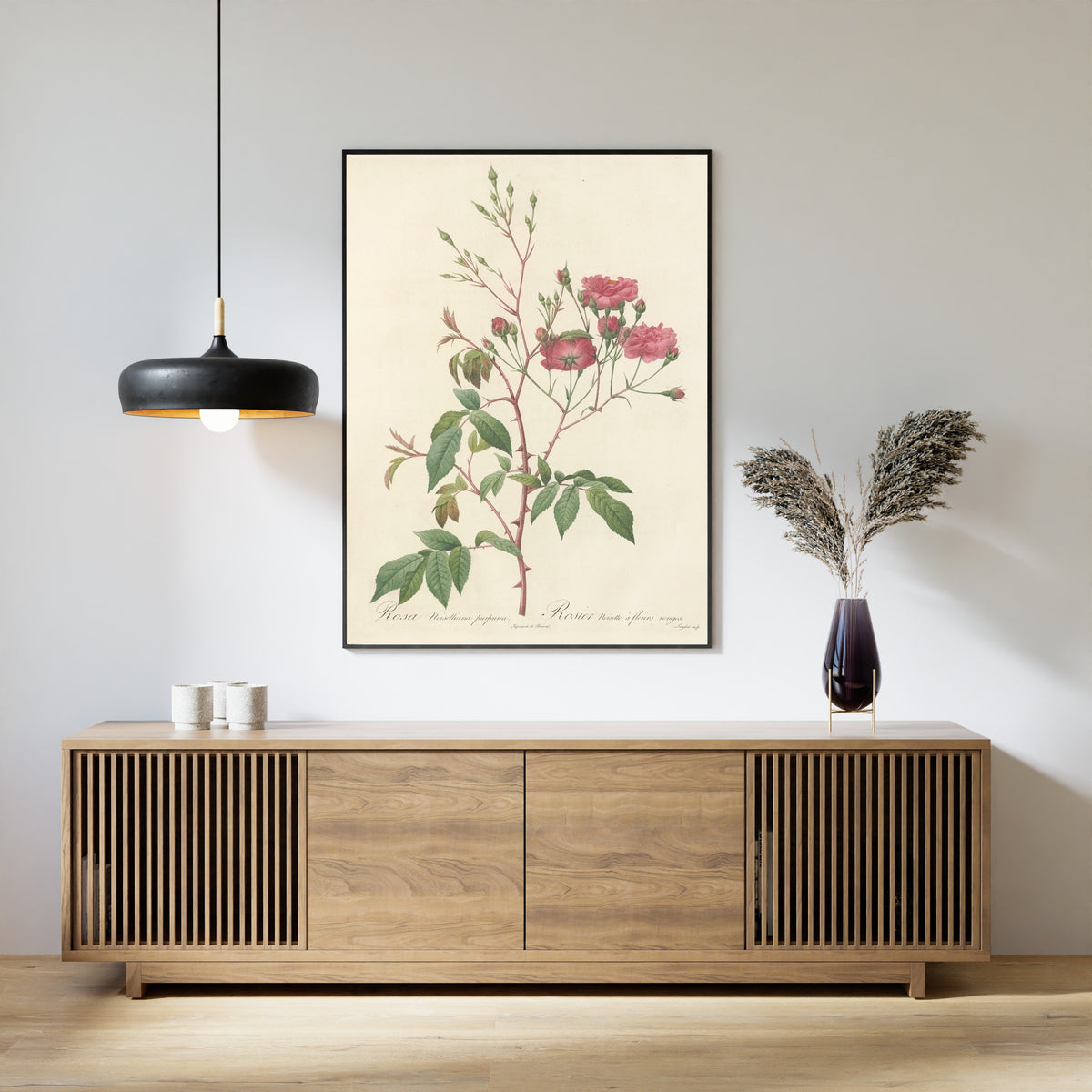 Framed art print of Les Roses: Rosa Noisettiana Purpurea by Pierre-Joseph Redouté, above a slatted wood sideboard