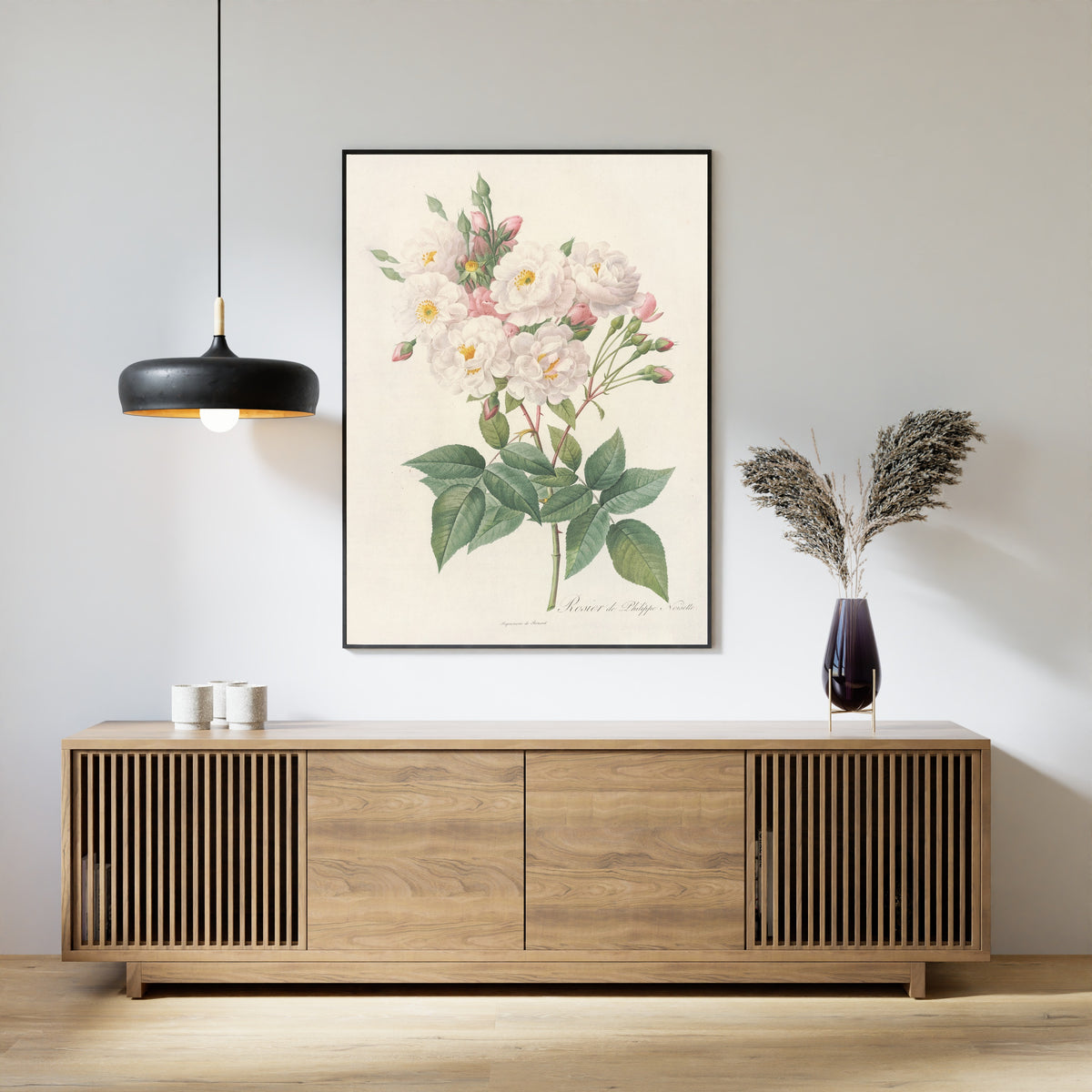 Framed art print of Les Roses: Rosa Noisettiana by Pierre-Joseph Redouté, above a slatted wood sideboard