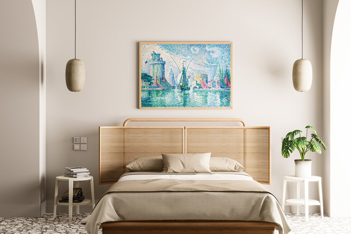 Framed art print of Les Tours Vertes, La Rochelle by Paul Signac, above a cane-headboard bed