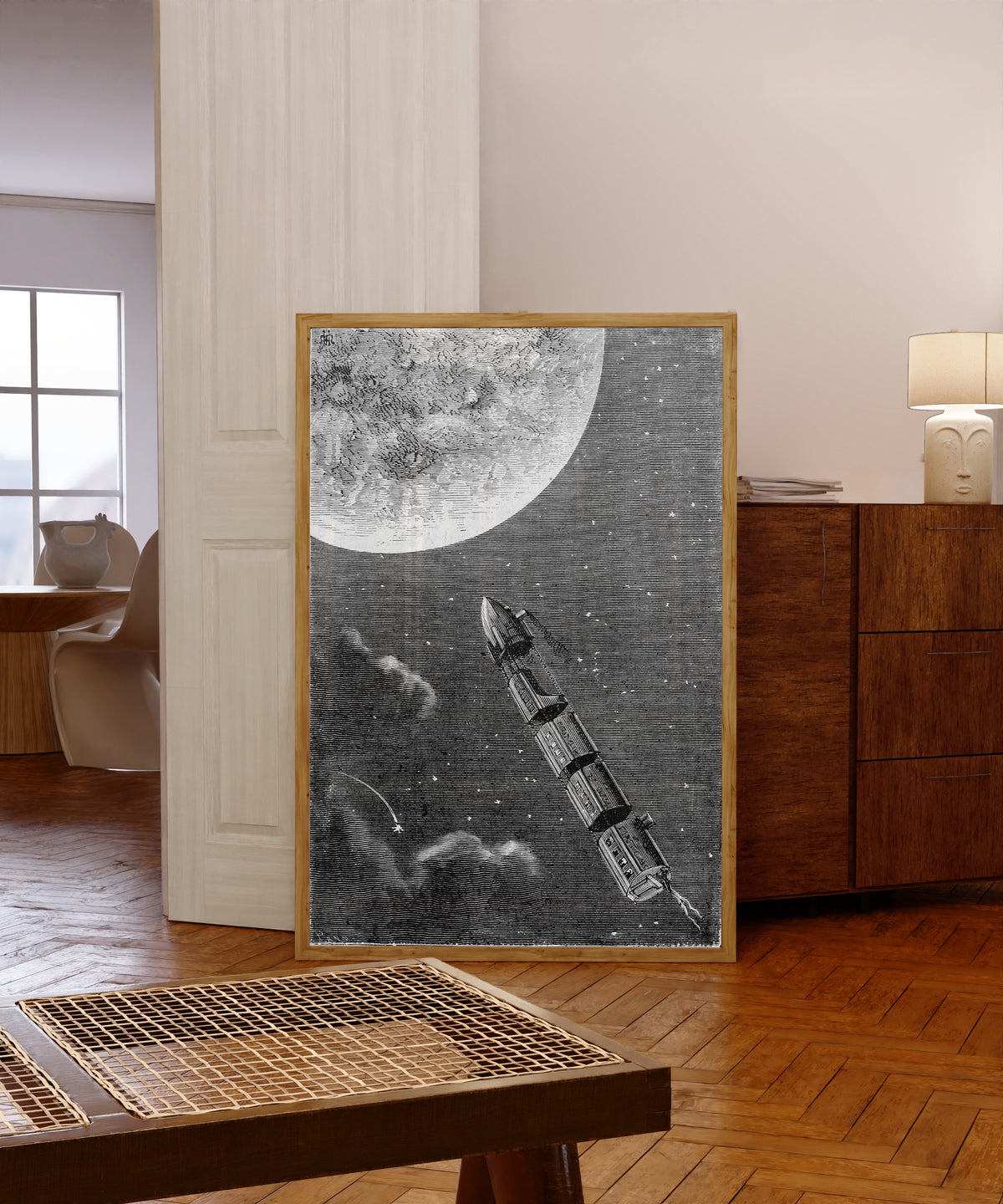 Framed art print of Les trains de projectiles pour la Lune (The… by Henri de Montaut, in a light wood frame leaning in a warm room with a parquet floor