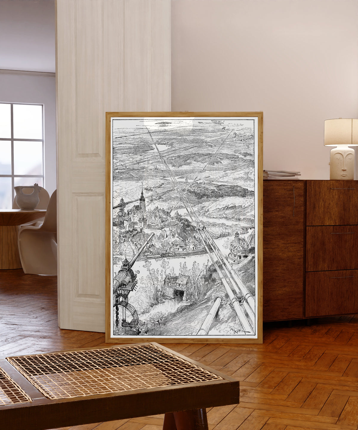 Framed art print of Les tubes (vue prise en aéronef à 700 mètres) by Albert Robida, in a light wood frame leaning in a warm room with a parquet floor