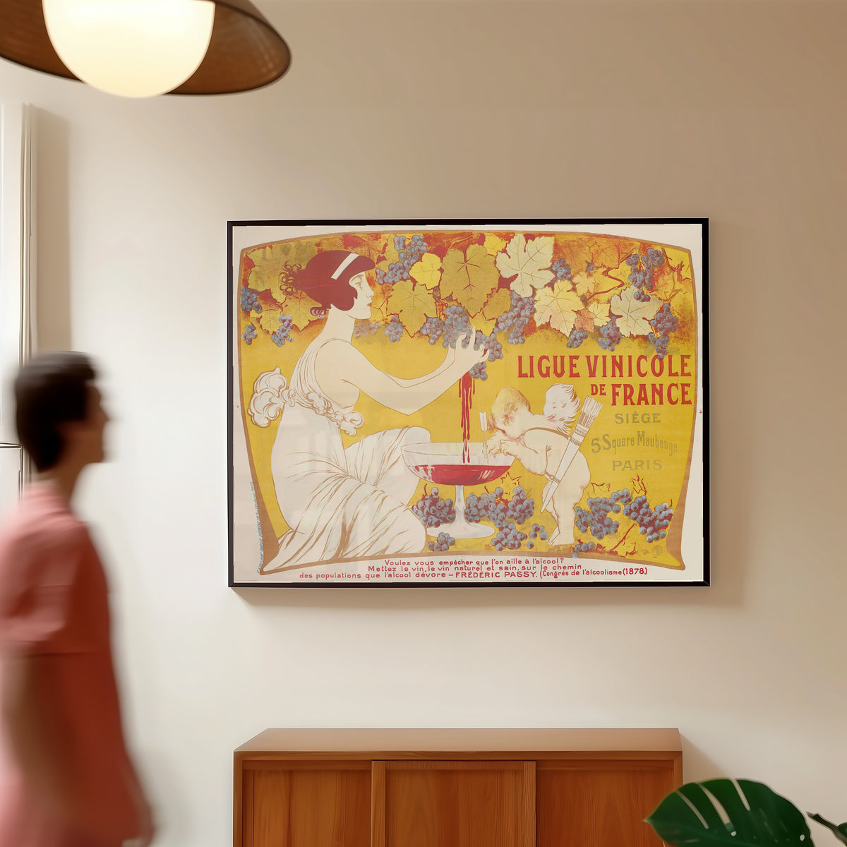 Framed art print of Ligue Vinicole de France by Manuel Orazi, in a slim black frame on a warm wall in a sunlit room