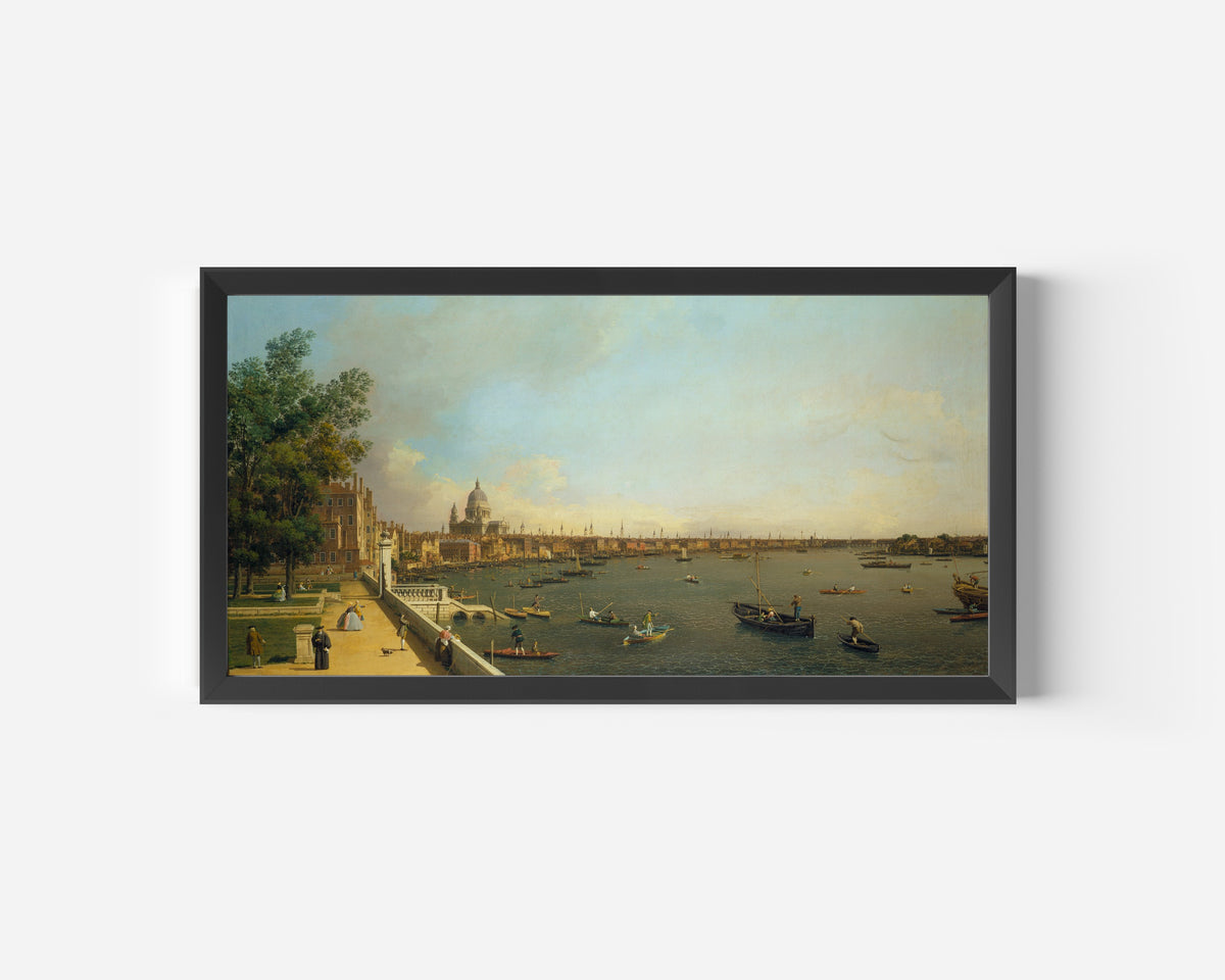 Framed art print of London – The Thames from Somerset House Terrace towards the City by Canaletto, in a wide black frame on a plain white wall