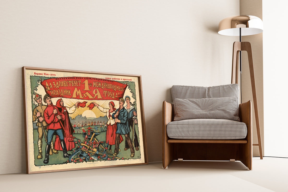 Framed art print of Long Live 1 May, the International Holiday of Labour! by Ivan Simakov, leaning against a wall beside an armchair and a floor lamp
