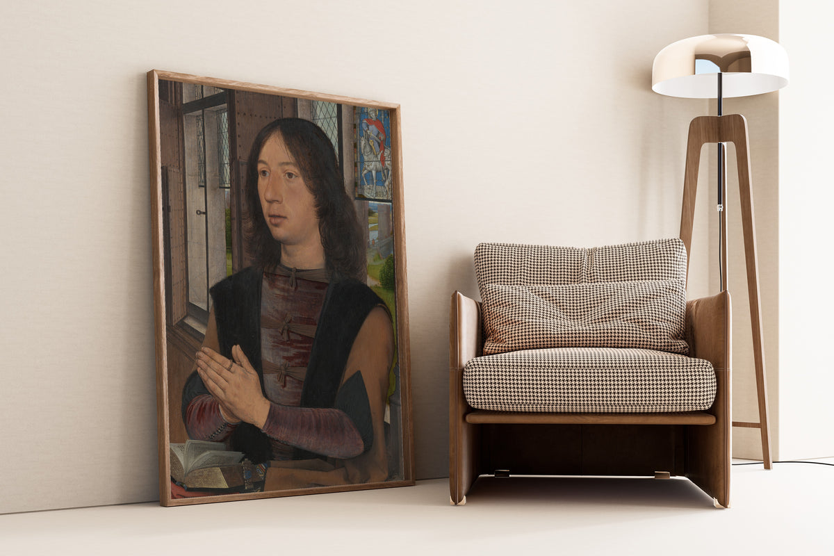 Framed art print of Maarten van Nieuwenhove by Hans Memling, leaning against a wall beside an armchair and a floor lamp