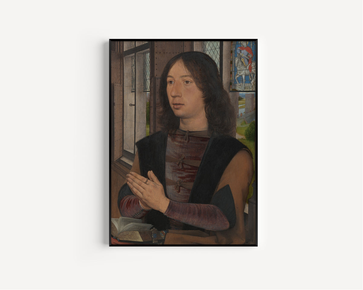 Framed art print of Maarten van Nieuwenhove by Hans Memling, in a slim black frame on a plain white wall