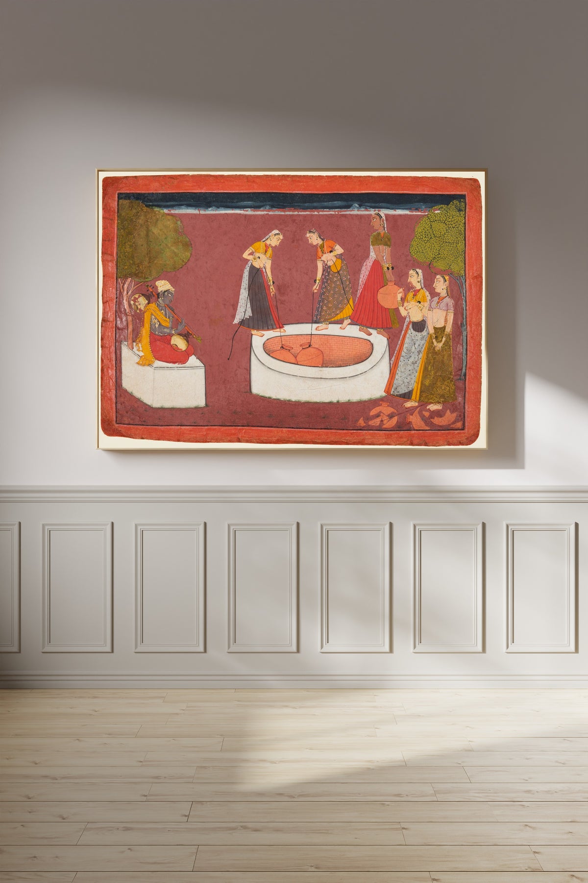 Framed art print of Madhava plays his vina before five women drawing water from a well by Pahari school, on a panelled wall in afternoon light