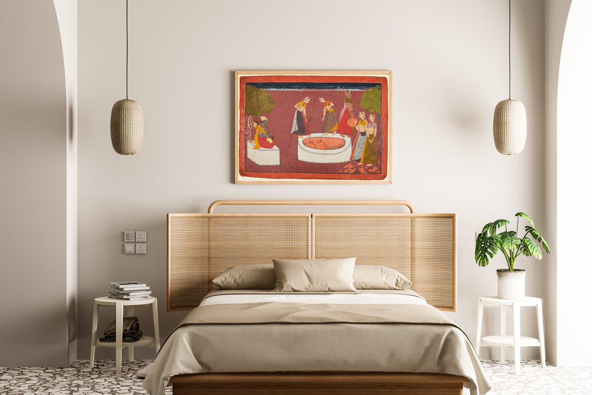 Framed art print of Madhava plays his vina before five women drawing water from a well by Pahari school, above a cane-headboard bed