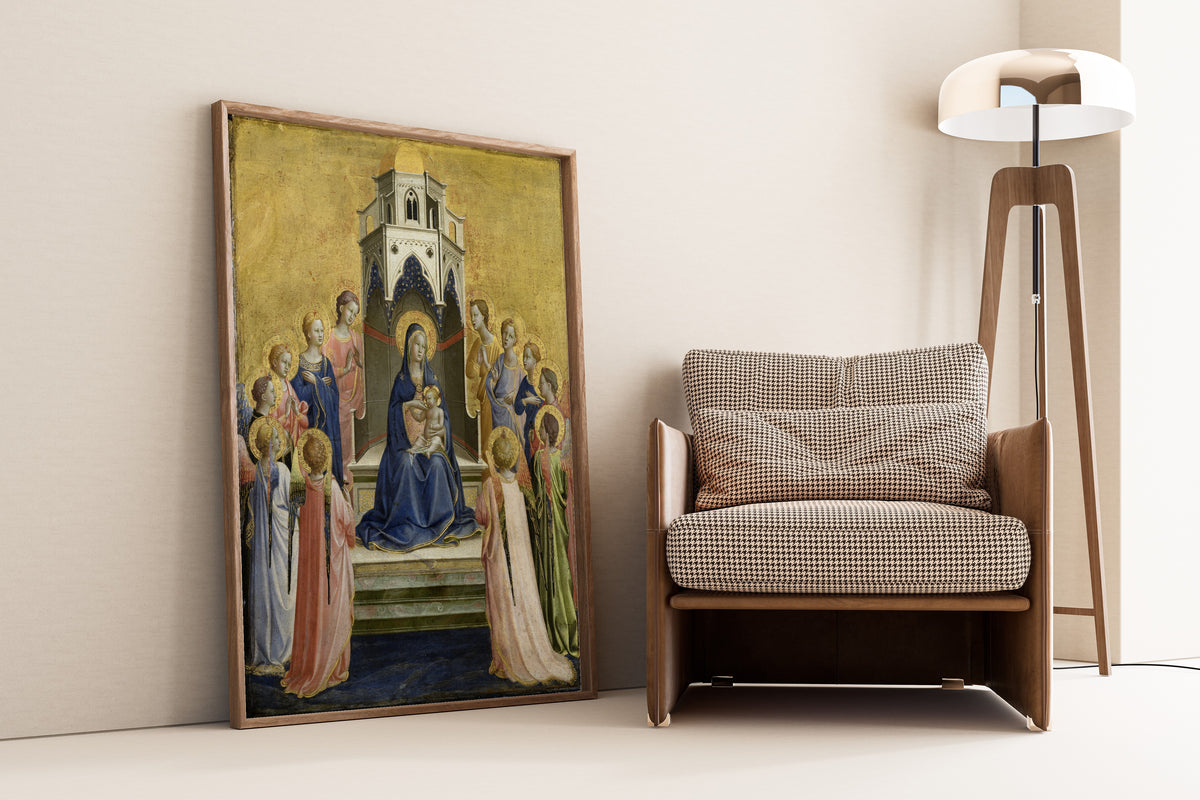 Framed art print of Madonna and Child Enthroned and Twelve Angels by Fra Angelico, leaning against a wall beside an armchair and a floor lamp