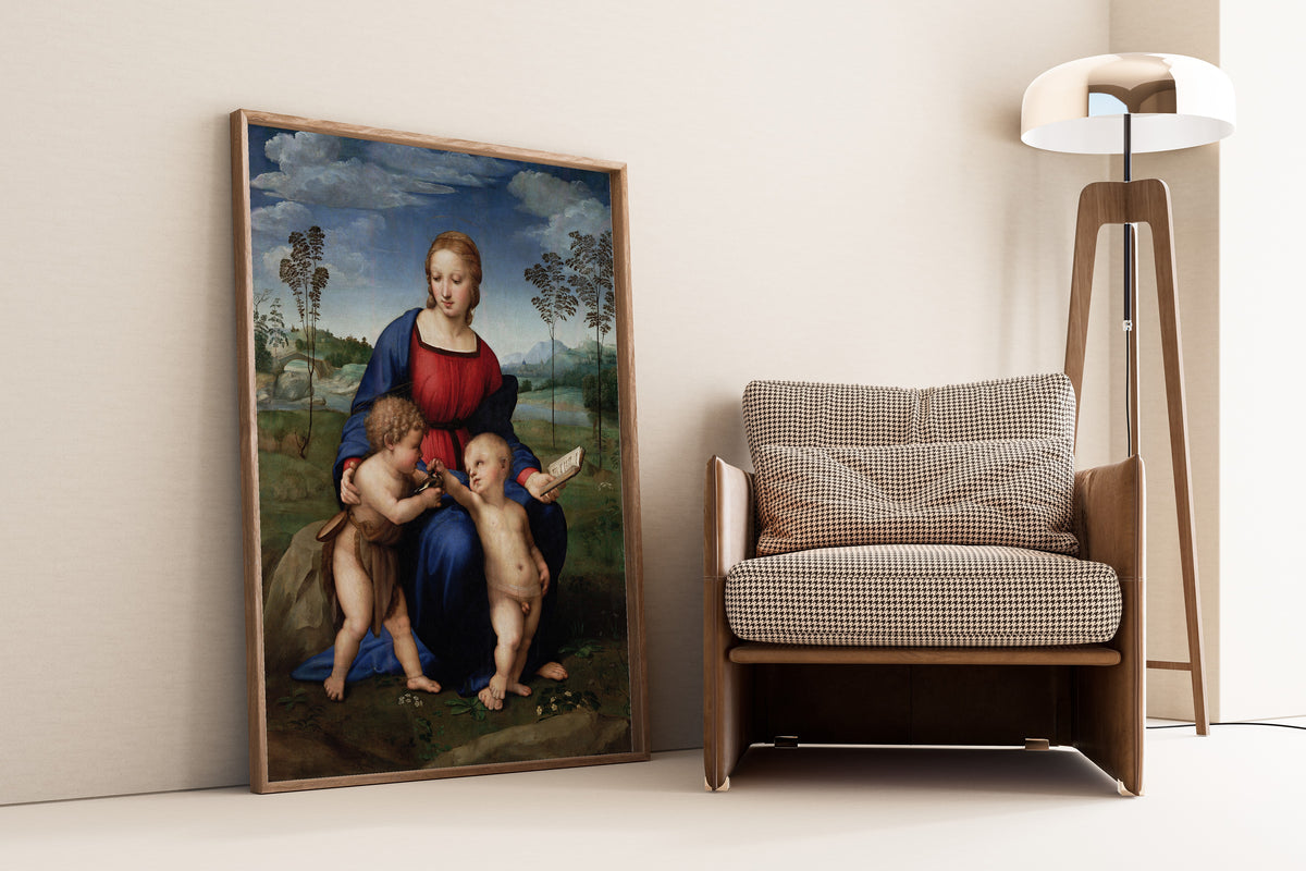 Framed art print of Madonna del Cardellino by Raphael, leaning against a wall beside an armchair and a floor lamp