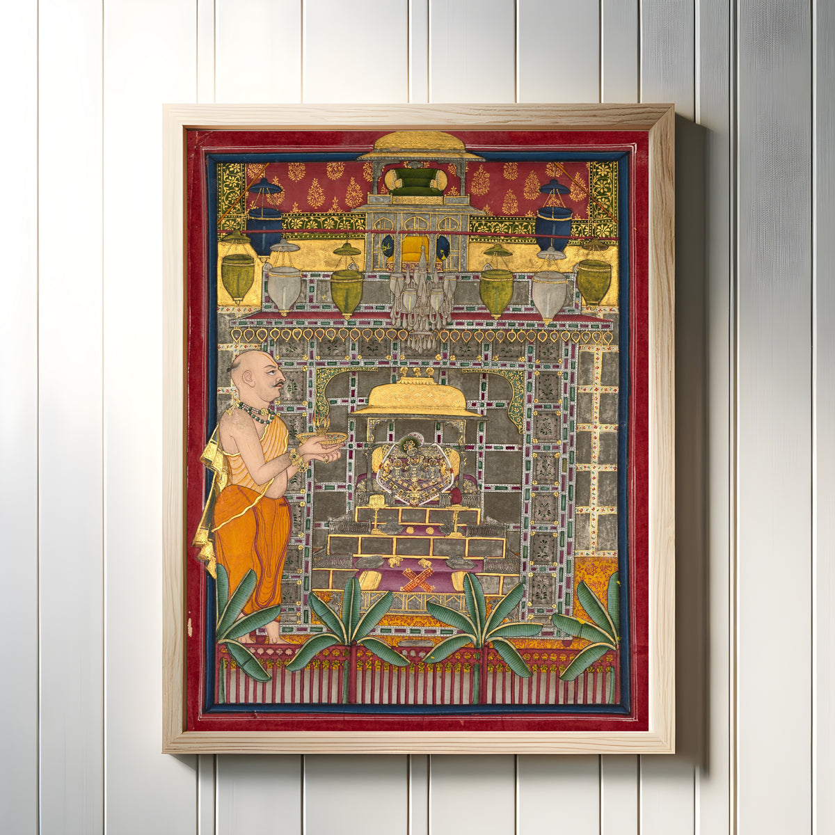 Framed art print of Maharao Kishor Singh II of Kota (r. 1819–28) Worshiping Krishna as Brij Rajji by Kota school, in a light wood frame on a white panelled wall