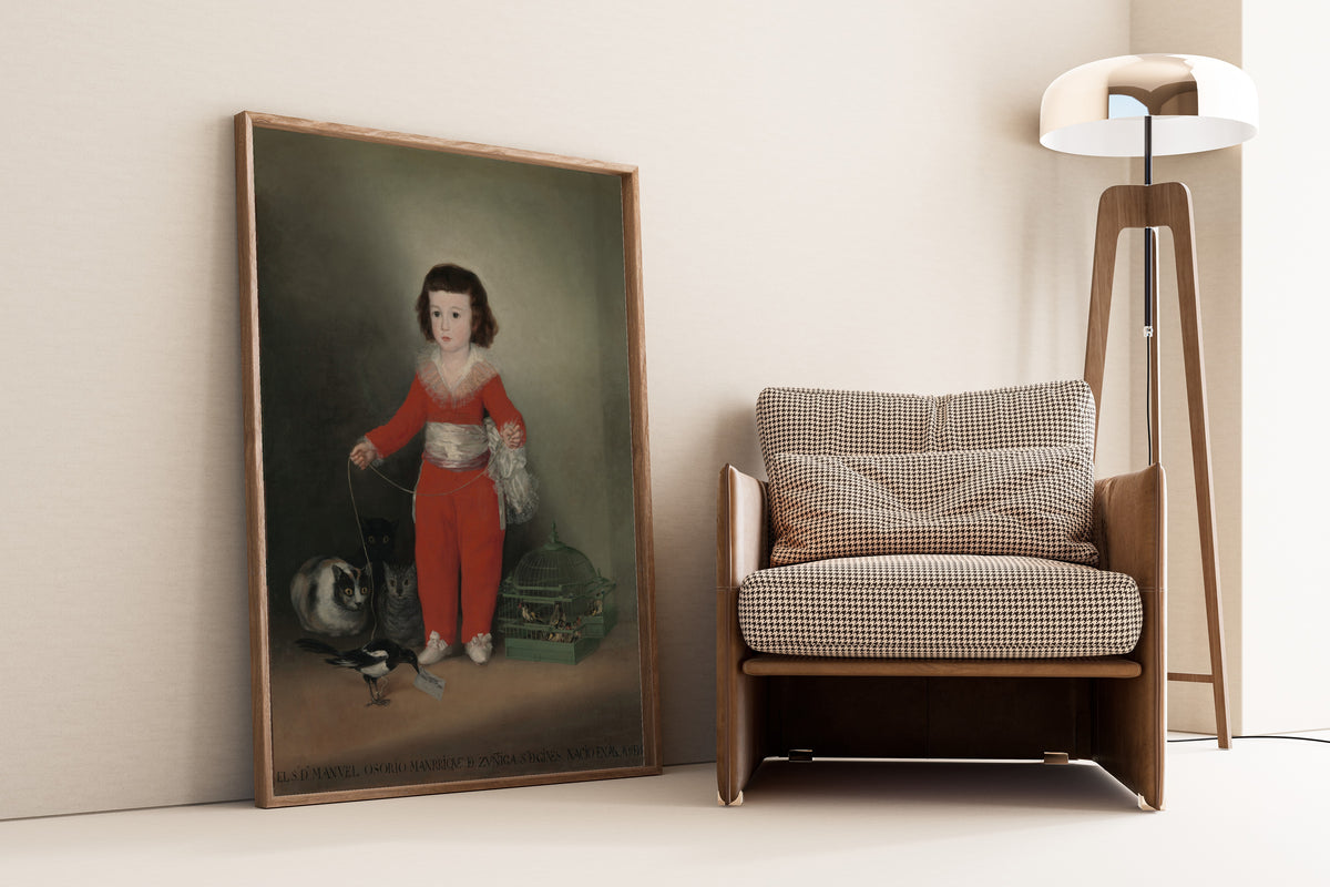 Framed art print of Manuel Osorio Manrique de Zuñiga (1784–1792) by Francisco de Goya, leaning against a wall beside an armchair and a floor lamp