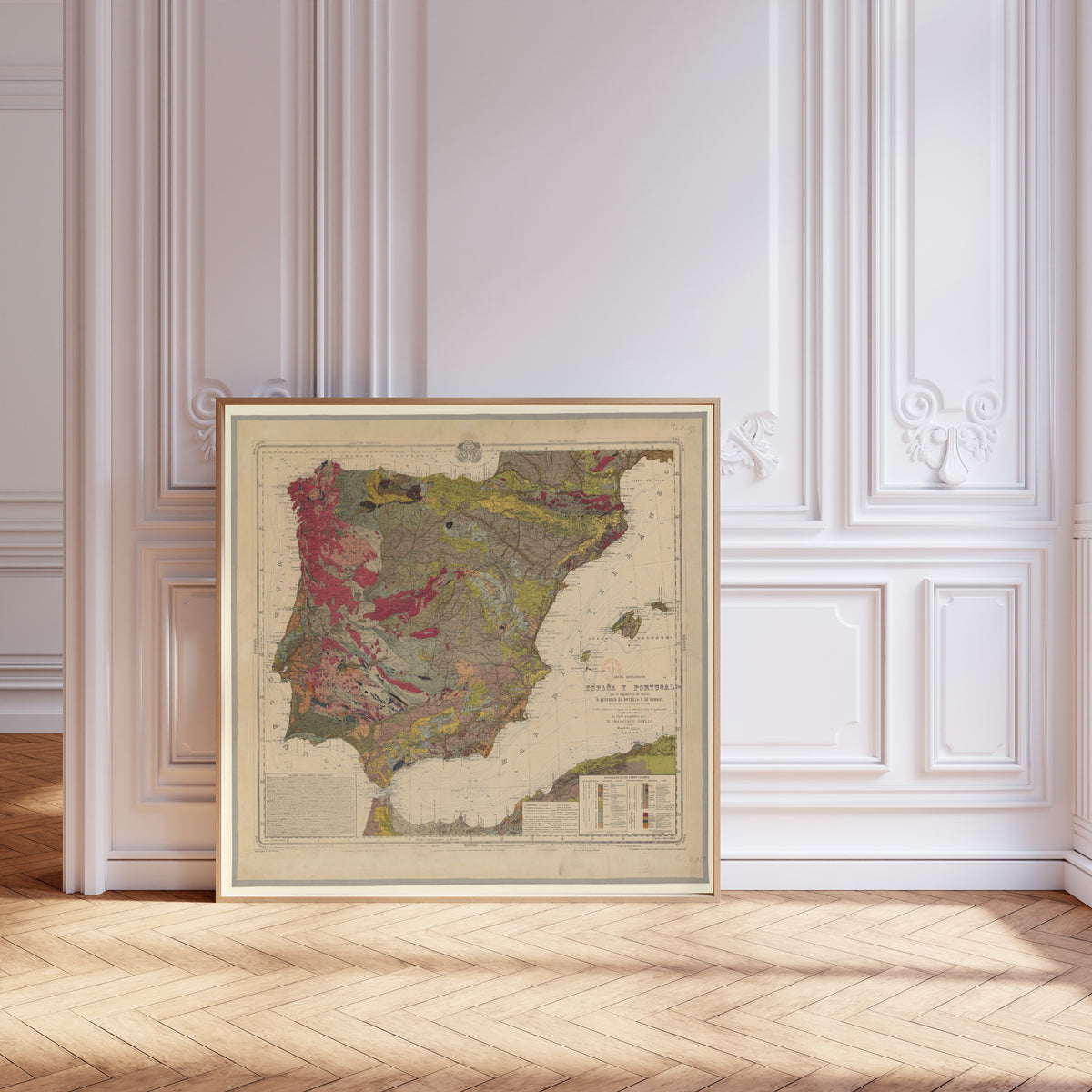 Mapa geológico de España y Portugal by Federico de Botella y de Hornos — framed and leaning against pale pink panelling on a herringbone floor