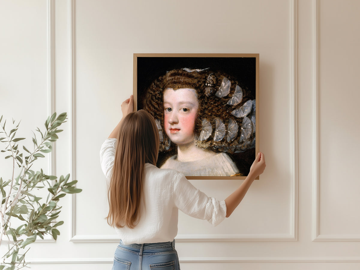 Framed art print of María Teresa, Infanta of Spain by Diego Velázquez, hung on a panelled wall
