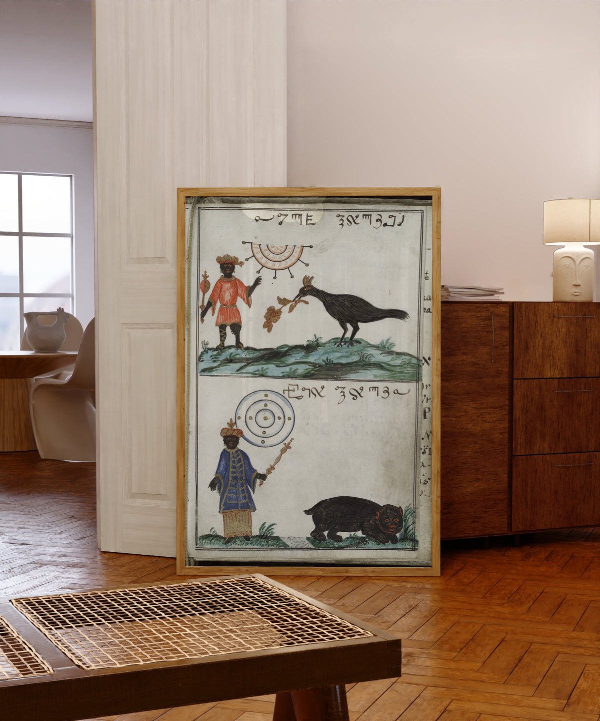 Framed art print of Maymon and Egyn, from Cyprianus by Unknown artist, in a light wood frame leaning in a warm room with a parquet floor
