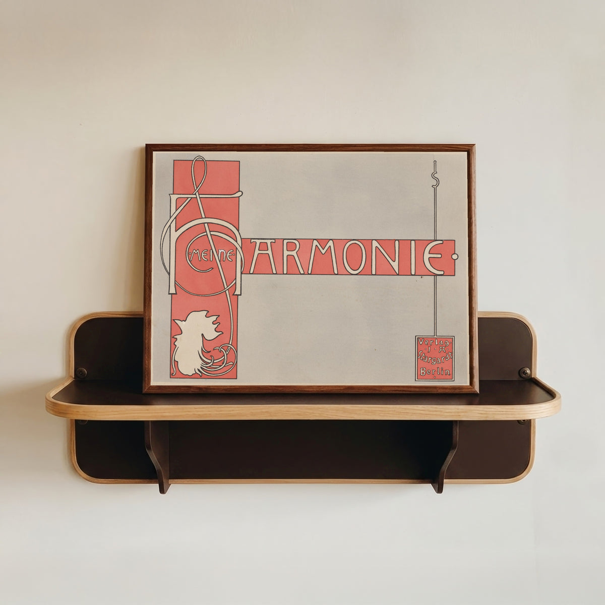 Framed art print of Meine Harmonie: Title Page by Joseph Sattler, in a dark wood frame resting on a wall shelf