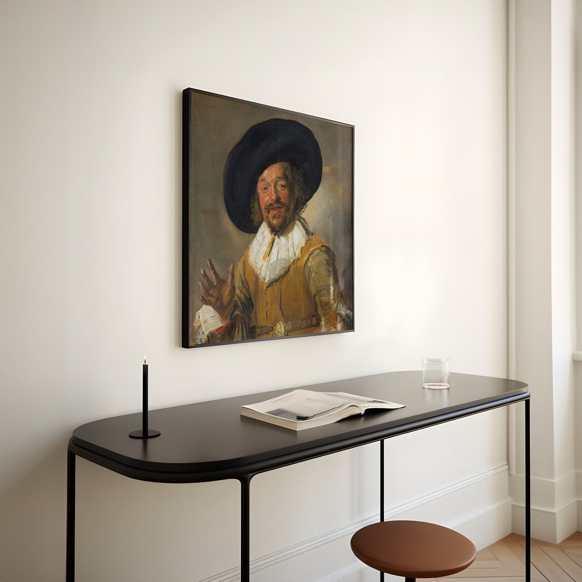 Framed art print of Merry Drinker by Frans Hals, above a slim black console table