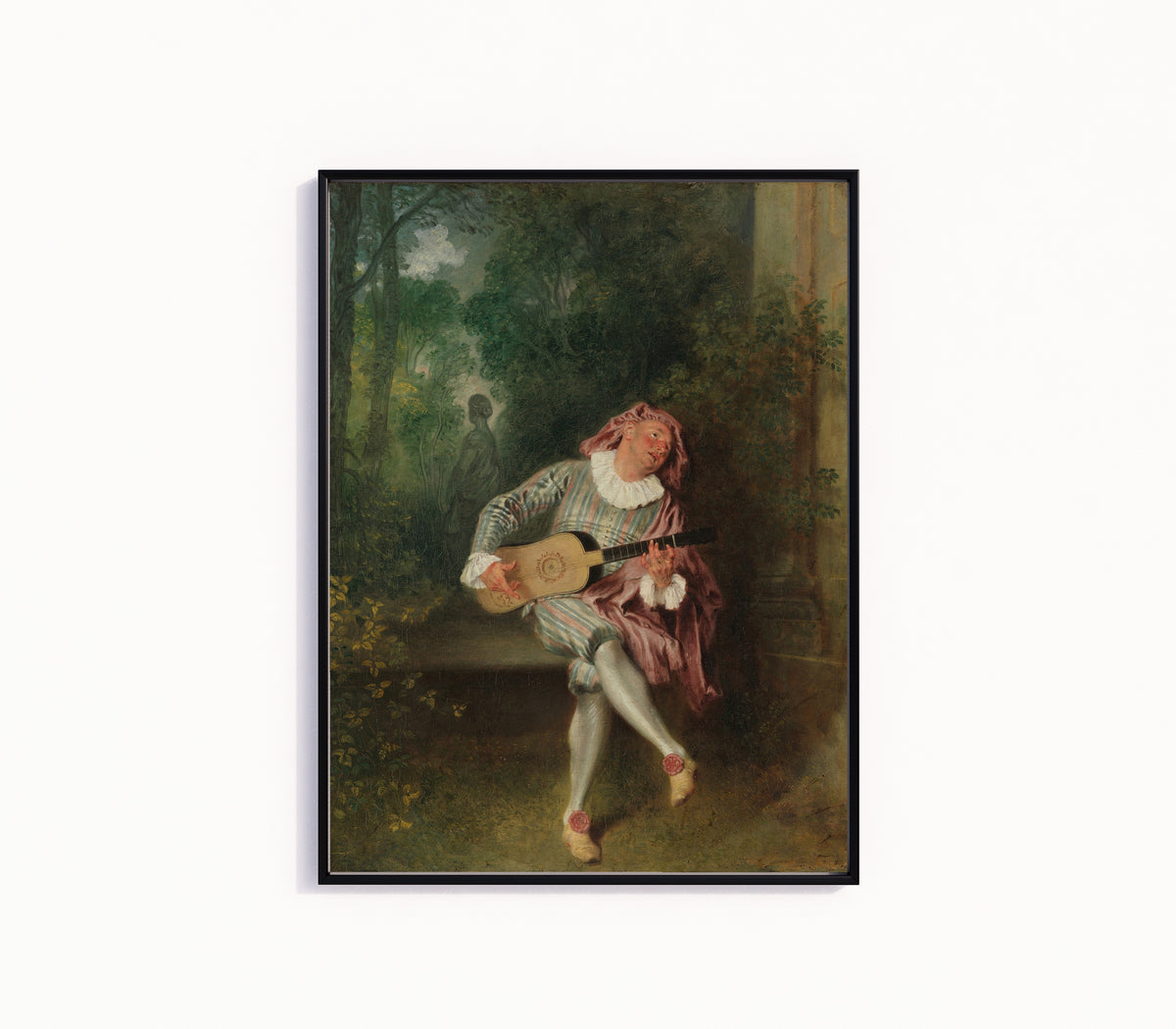 Framed art print of Mezzetin by Jean-Antoine Watteau, in a slim black frame on a plain white wall