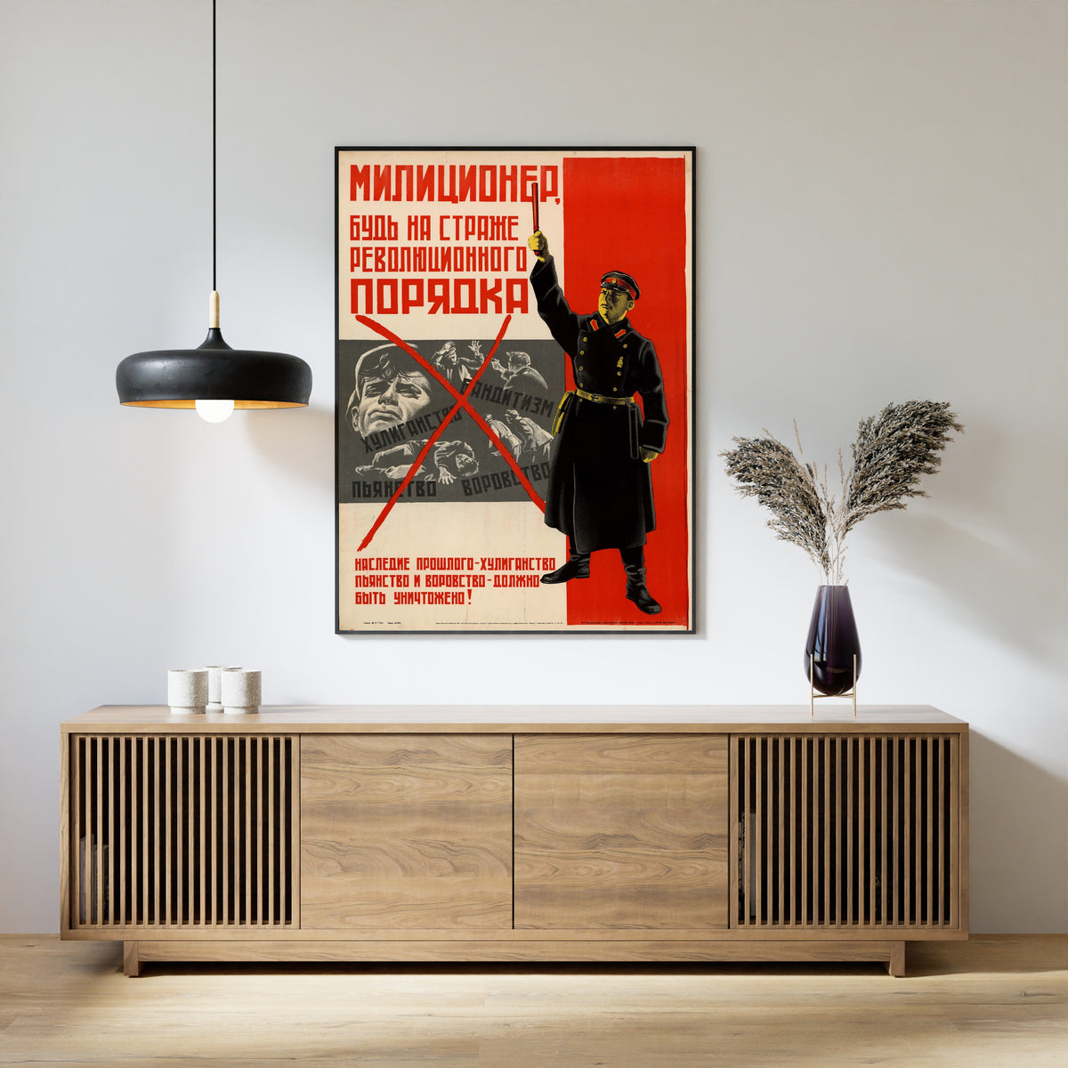 Framed art print of Militiaman, Be on Guard of Revolutionary Order, above a slatted wood sideboard