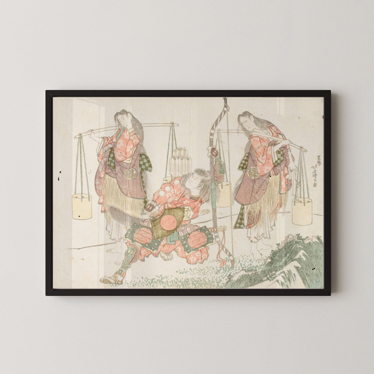 Framed art print of Minamoto no Tametomo and Two Salt Gatherers by Katsushika Hokusai, in a black frame on a pale wall