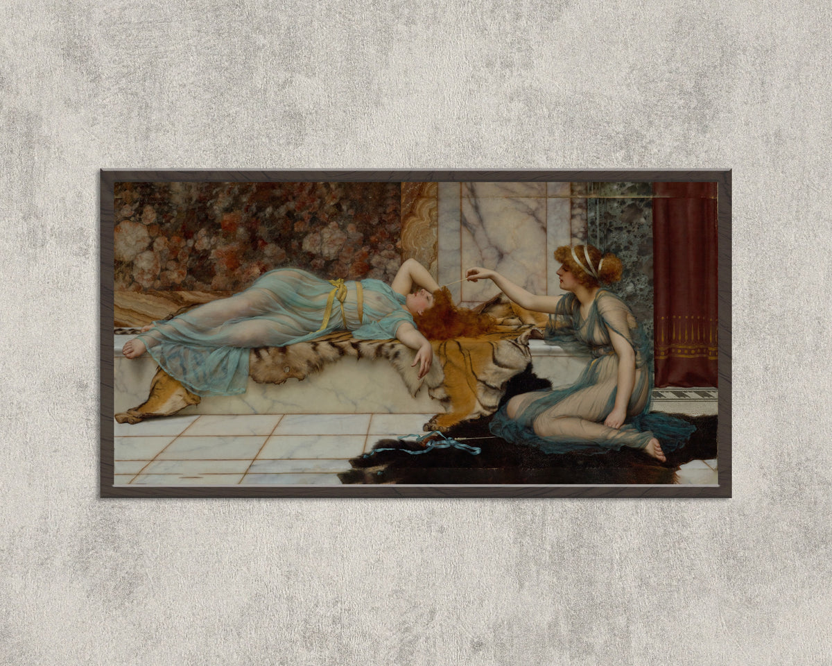 Framed art print of Mischief and Repose by John William Godward, in a wide black frame on a concrete wall
