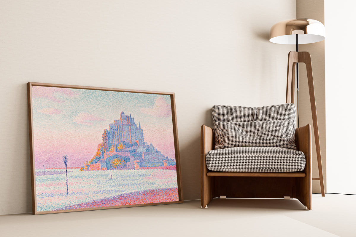 Framed art print of Mont Saint-Michel, Setting Sun by Paul Signac, leaning against a wall beside an armchair and a floor lamp