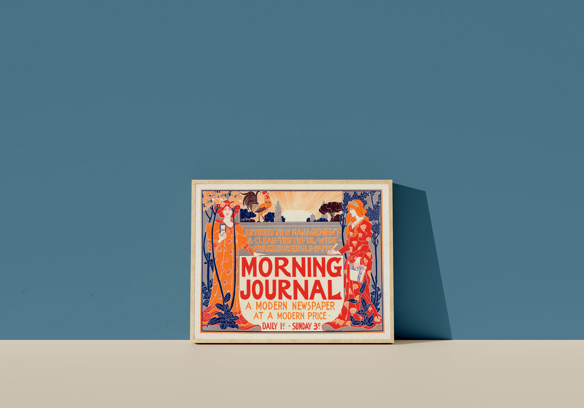 Framed art print of Morning Journal by Louis Rhead, in a light wood frame leaning on a blue wall
