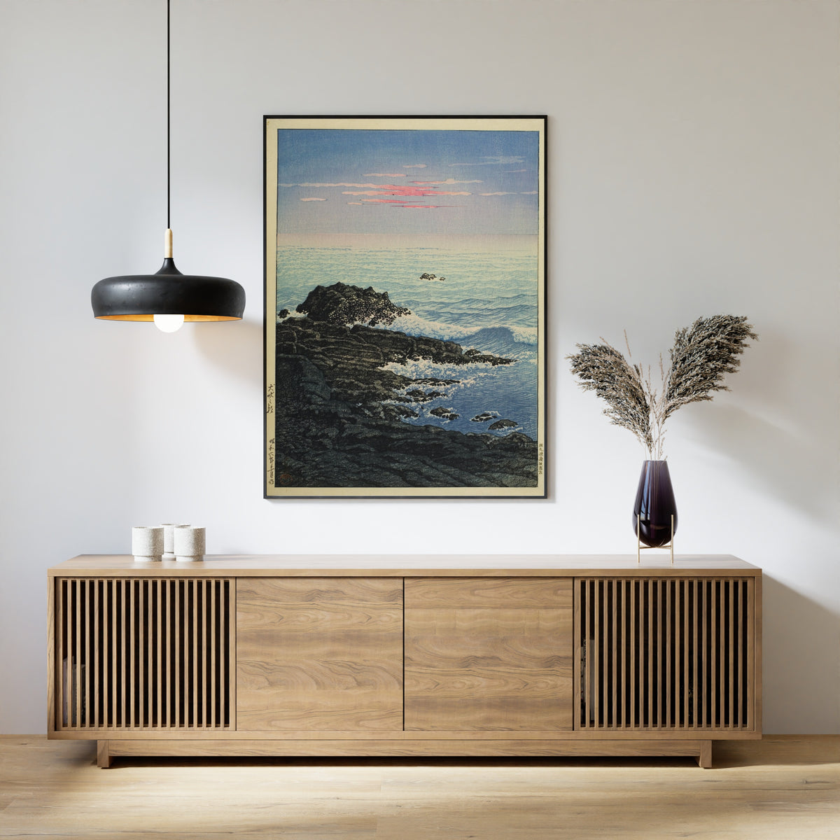 Framed art print of Morning at Cape Inubo by Kawase Hasui, above a slatted wood sideboard