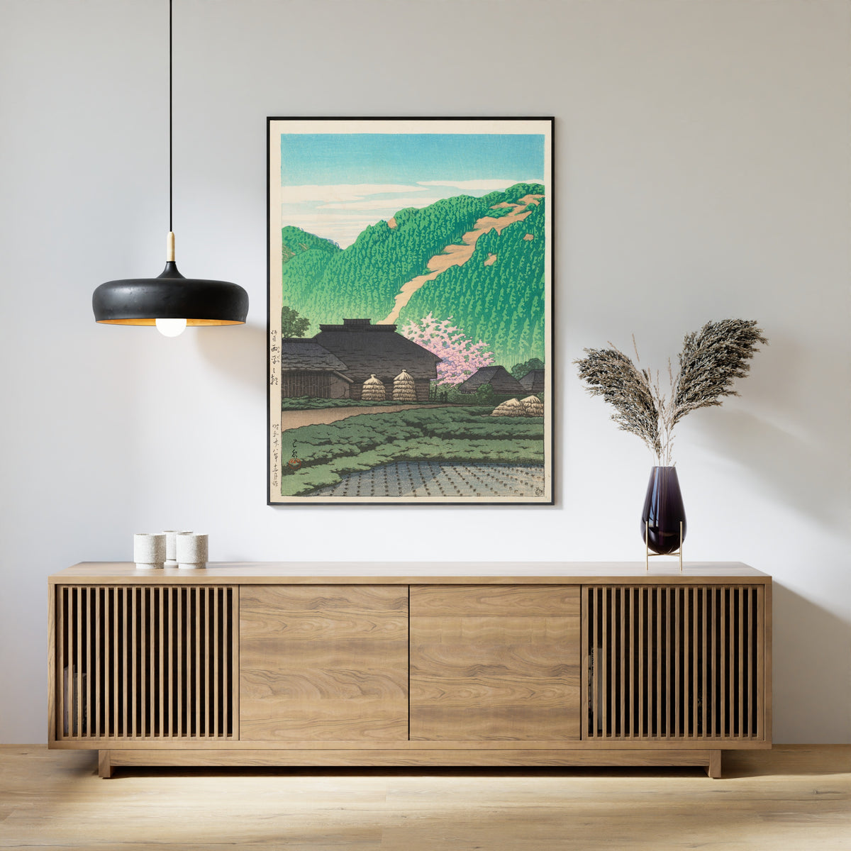 Framed art print of Morning in Nishibira, Izu by Kawase Hasui, above a slatted wood sideboard