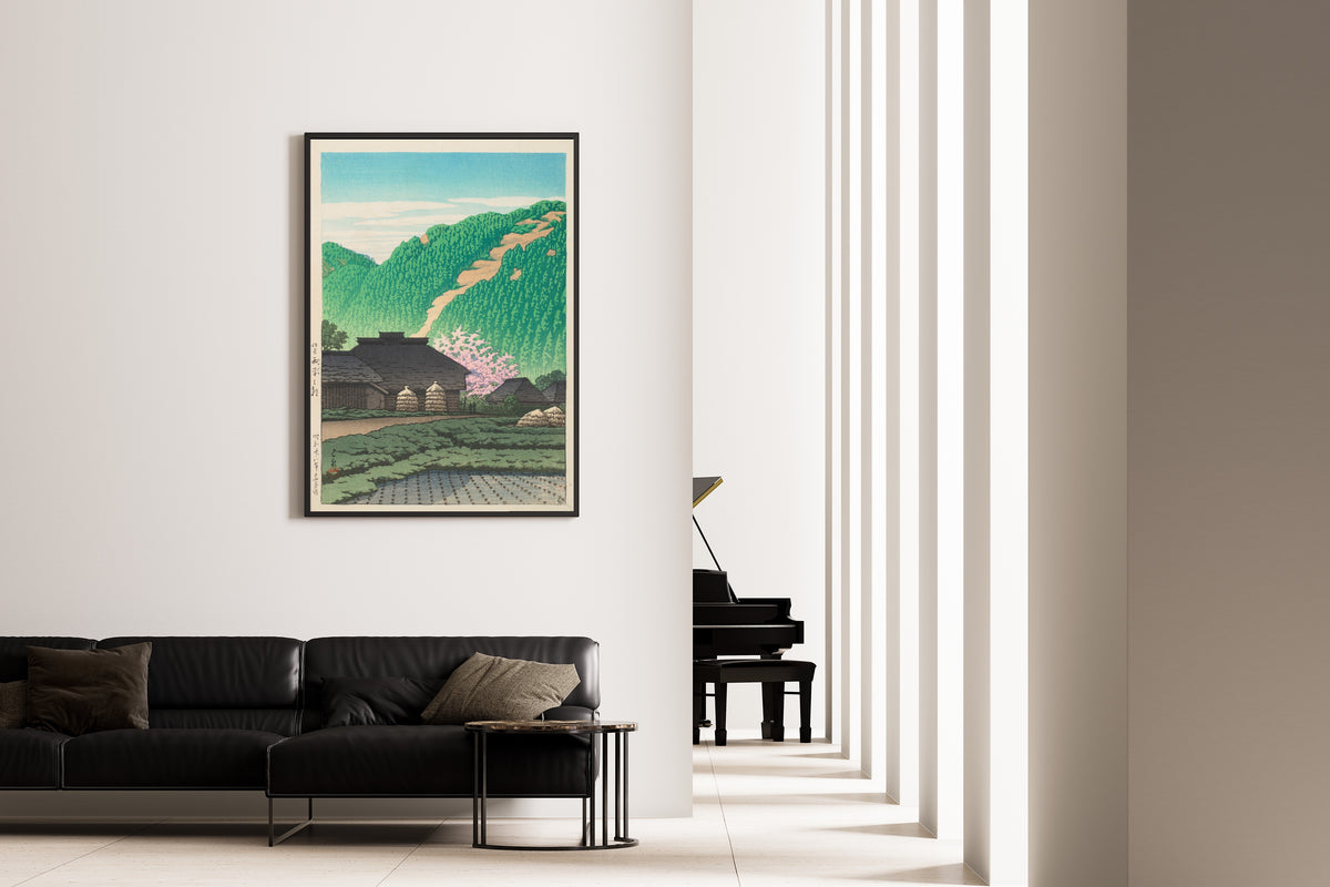 Framed art print of Morning in Nishibira, Izu by Kawase Hasui, on the wall of a minimal living room