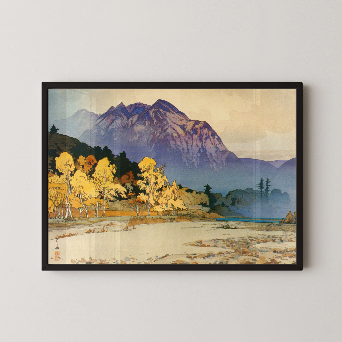 Framed art print of Mount Hodaka after Rain by Hiroshi Yoshida, in a black frame on a pale wall