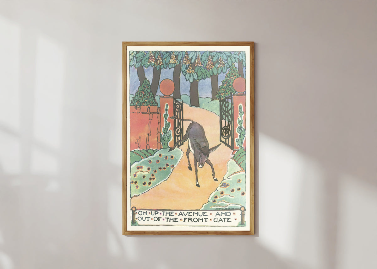 Framed art print of Mummy's Bedtime Story Book: On Up the Avenue and Out of the Front Gate by Jessie M. King, in a light wood frame on a sunlit white wall