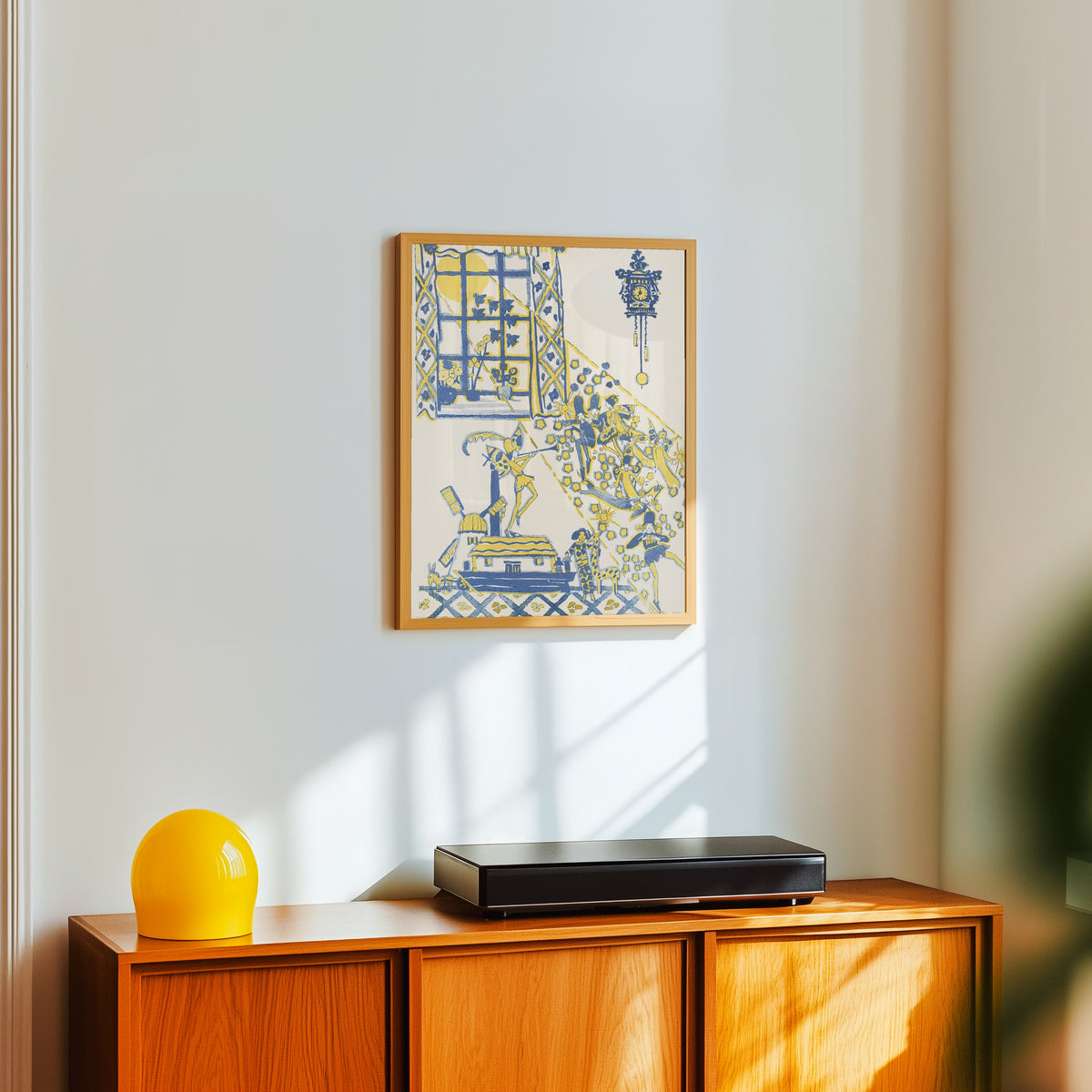 Framed art print of Mummy's Bedtime Story Book: Plate 13 by Jessie M. King, in a light wood frame on a white wall above an orange sideboard