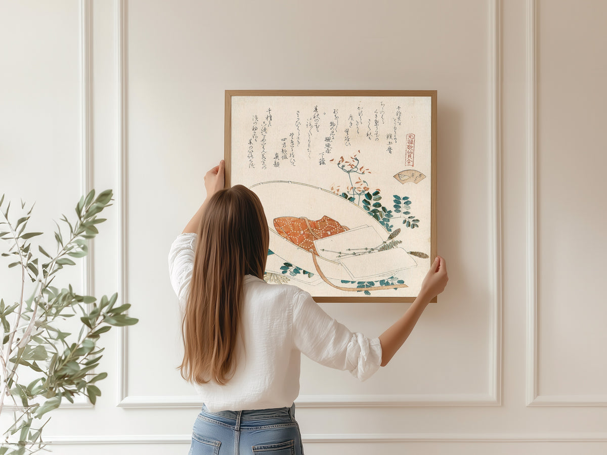 Framed art print of Myriad Grasses Shell by Katsushika Hokusai, hung on a panelled wall
