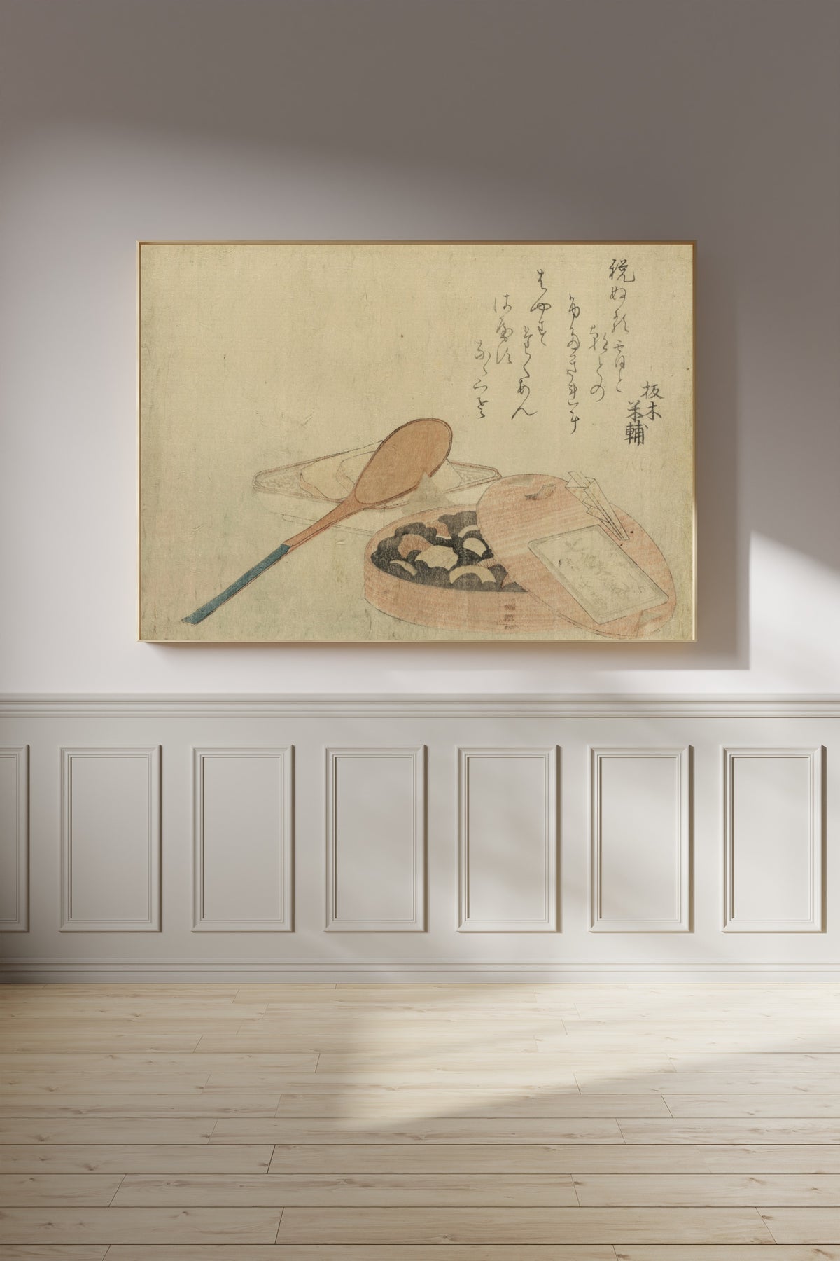 Framed art print of Nanairo Zazenmame by Katsushika Hokusai, on a panelled wall in afternoon light