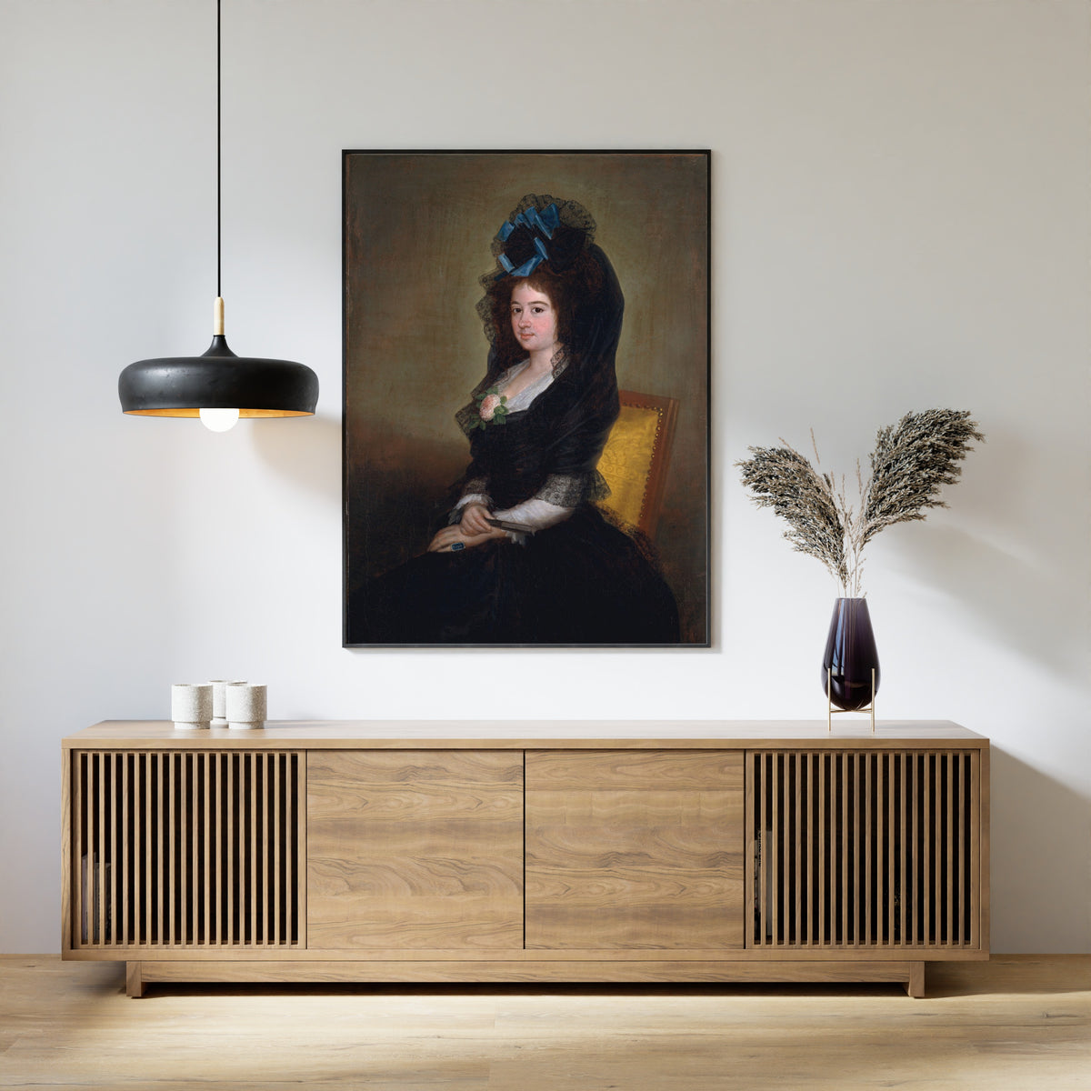 Framed art print of Narcisa Barañano Gayoso de Goicoechea by Francisco de Goya, above a slatted wood sideboard