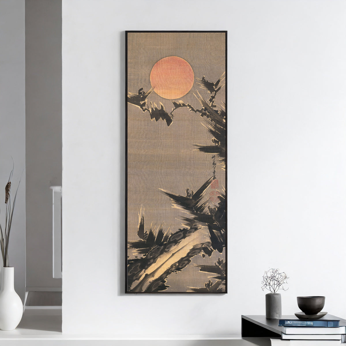 New Year's Sun and Old Pine Tree by Itō Jakuchū — framed on a white wall above books and a bowl