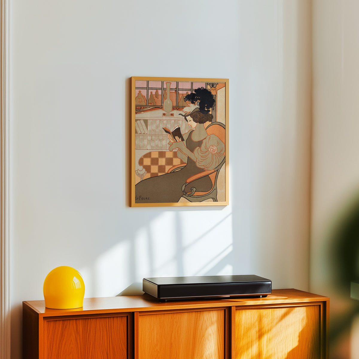 Framed art print of Nieuwjaarswens van Octave Uzanne voor het jaar 1897 by Georges de Feure, in a light wood frame on a white wall above an orange sideboard
