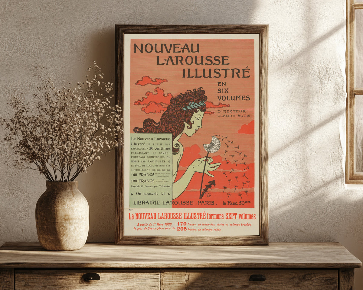 Framed art print of Nouveau Larousse Illustré by Eugène Grasset, in a dark wood frame leaning on a rustic console beside dried flowers