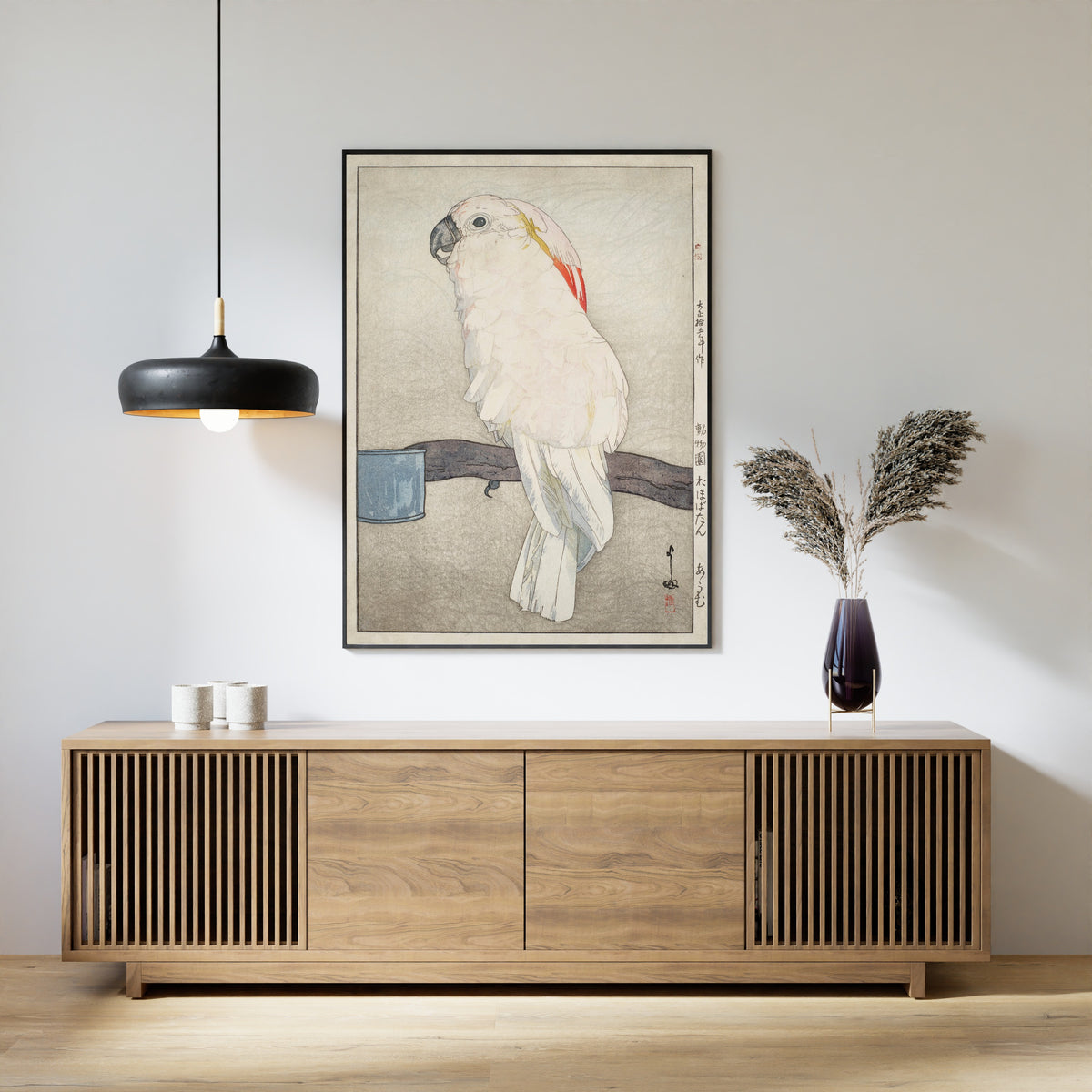 Framed art print of Obatan Parrot by Hiroshi Yoshida, above a slatted wood sideboard