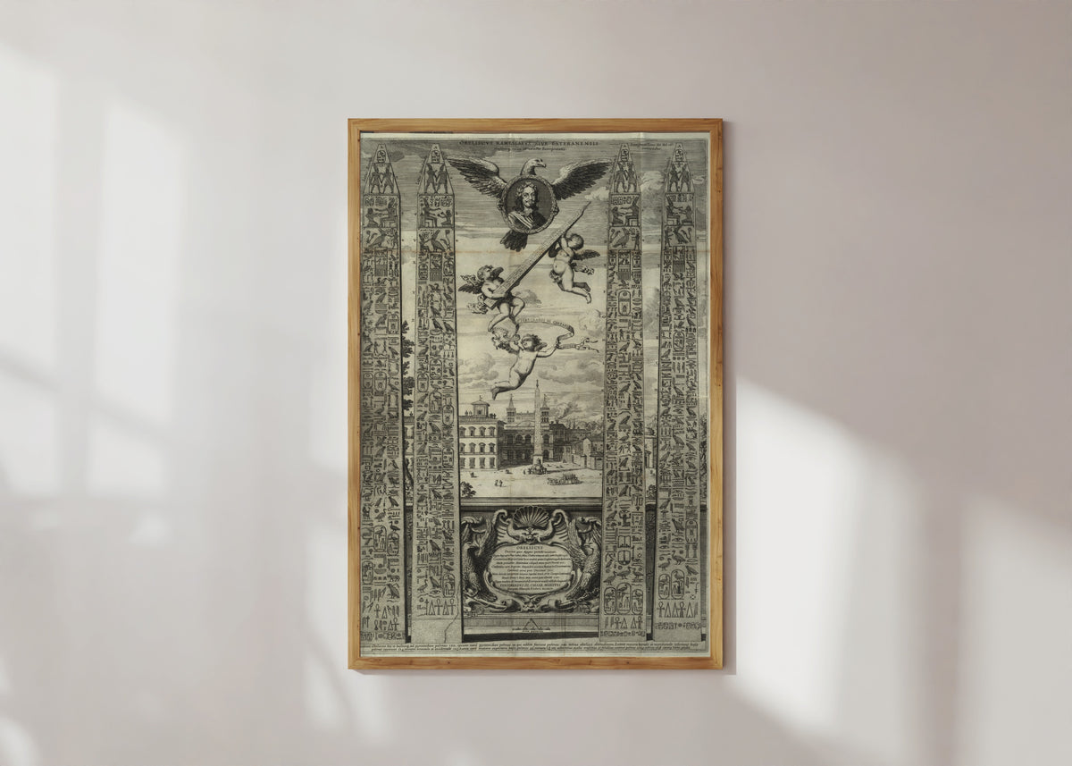 Framed art print of Obelisk Plate with Eagle and Cherubs (Oedipus Aegyptiacus) by Athanasius Kircher, in a light wood frame on a sunlit white wall